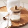Tarro de vidrio con cuchara y tapa de madera